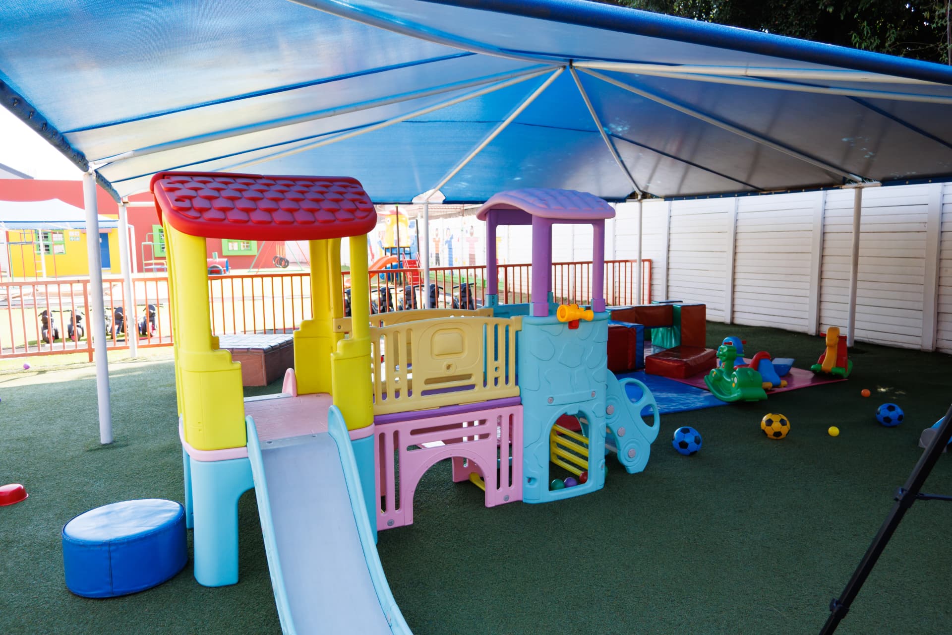 Toddler play house with slide under the shade net