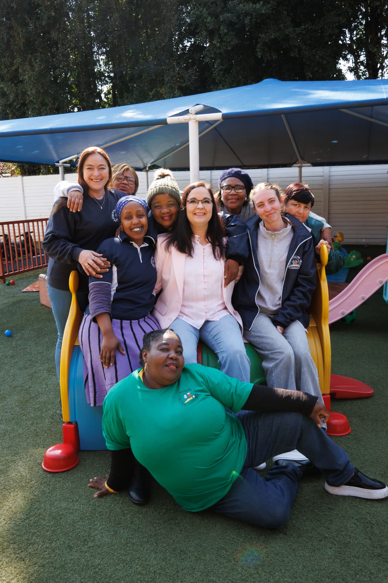 Millennium Kids staff team together on the playground