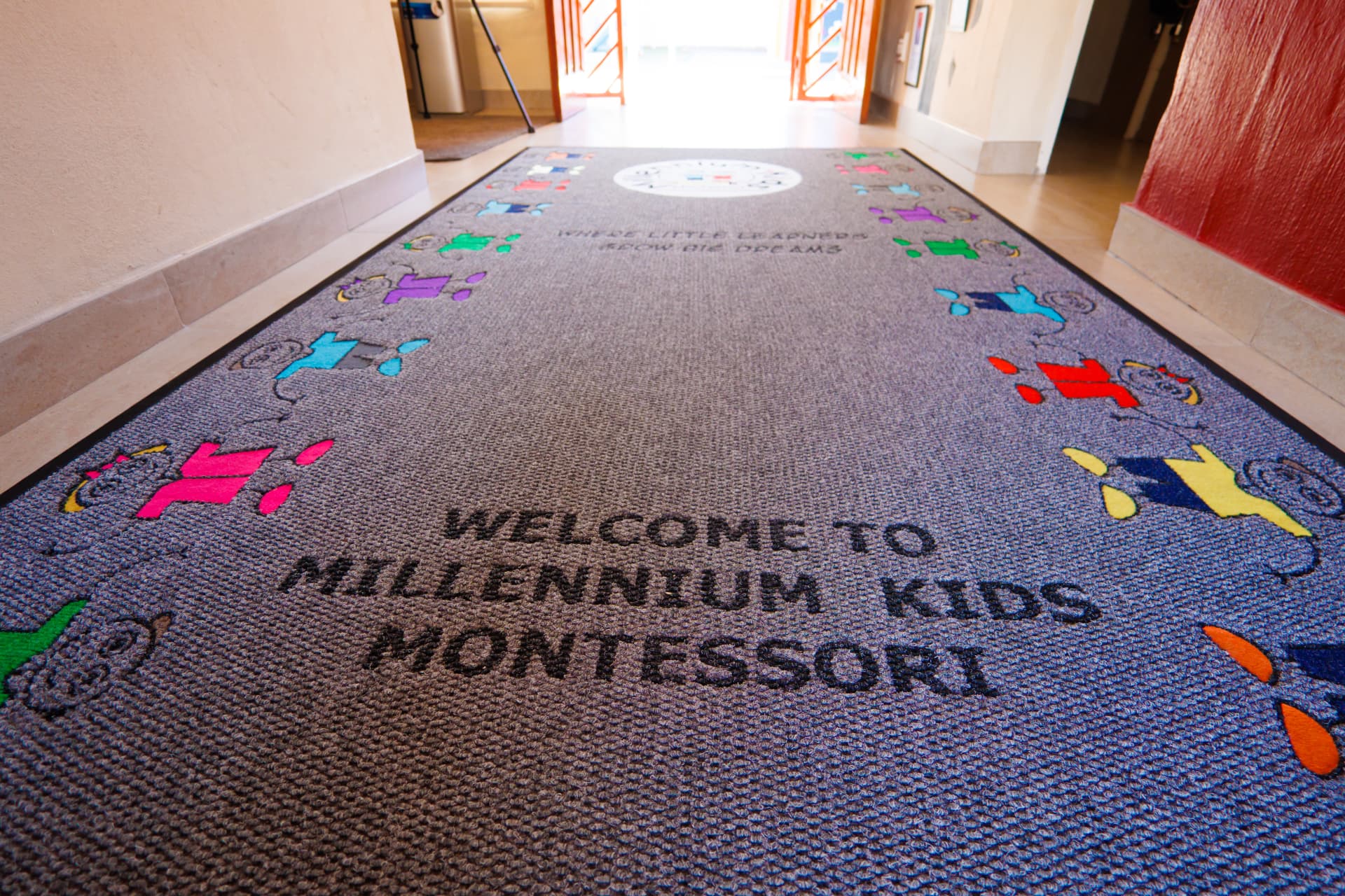 Welcome mat reading Welcome to Millennium Kids Montessori in the entrance hall