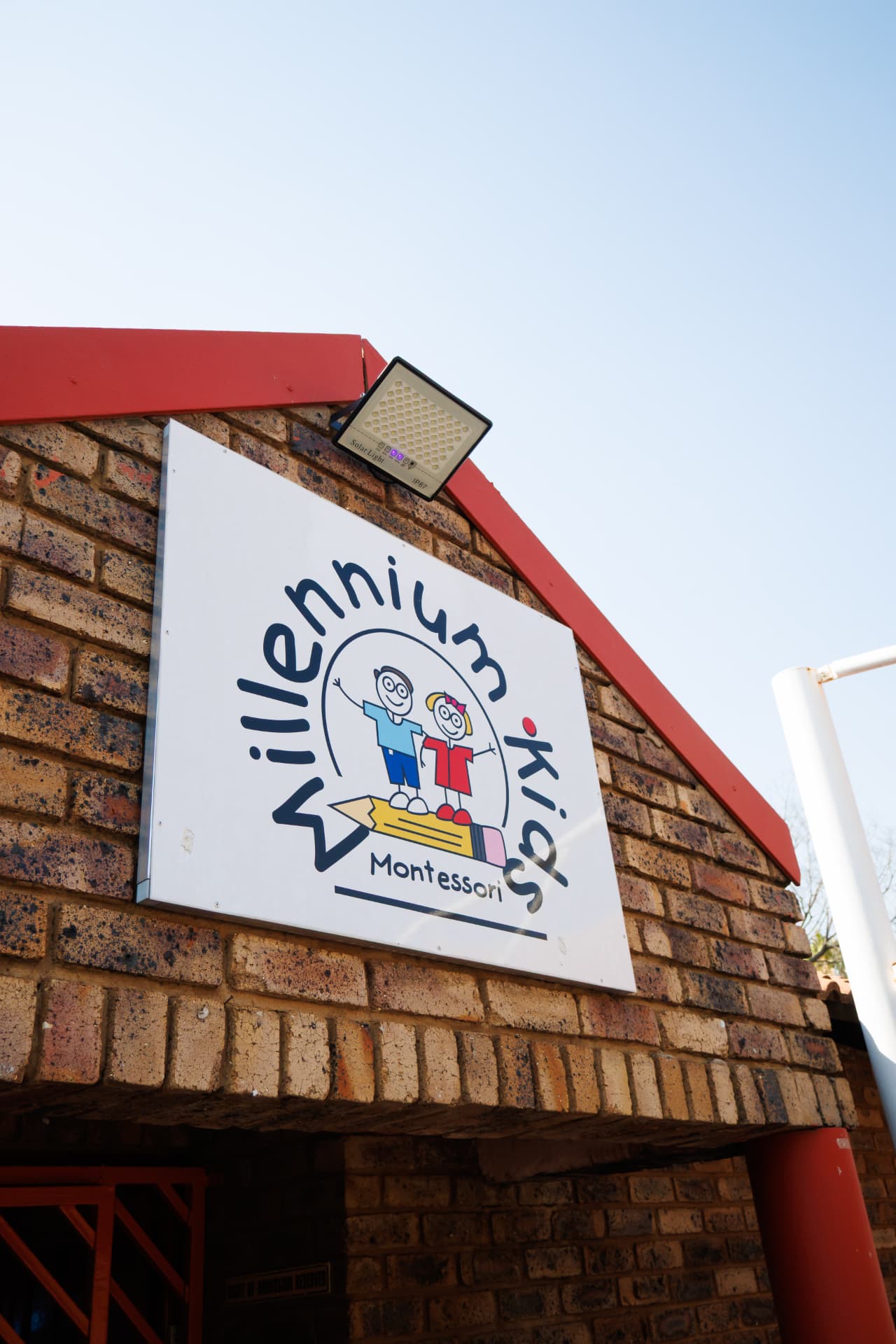 Millennium Kids Montessori school sign on the brick wall