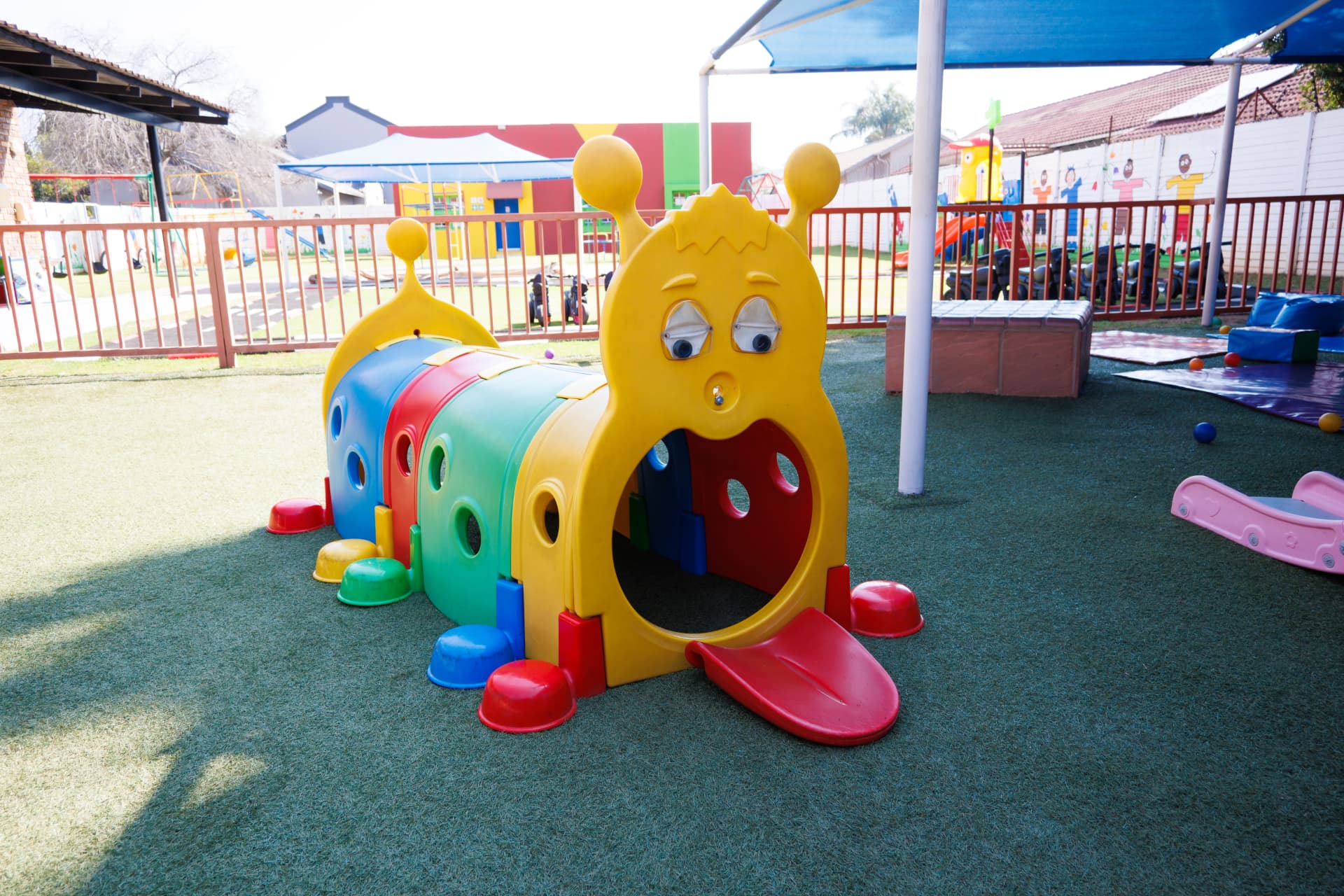 Caterpillar crawl tunnel play structure on the turf