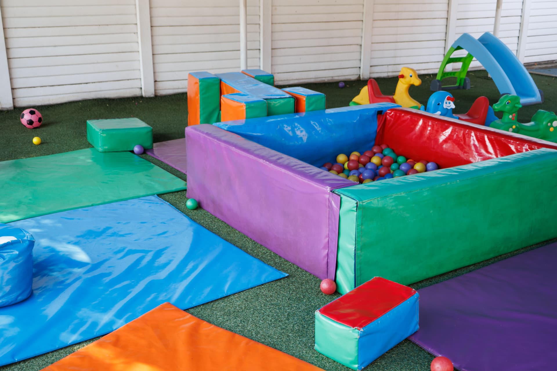 Soft play mats and ball pit with ride-on toys