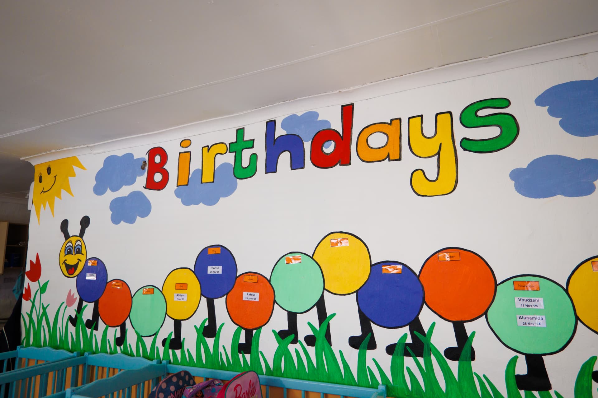 Painted birthdays wall with a caterpillar and children's names