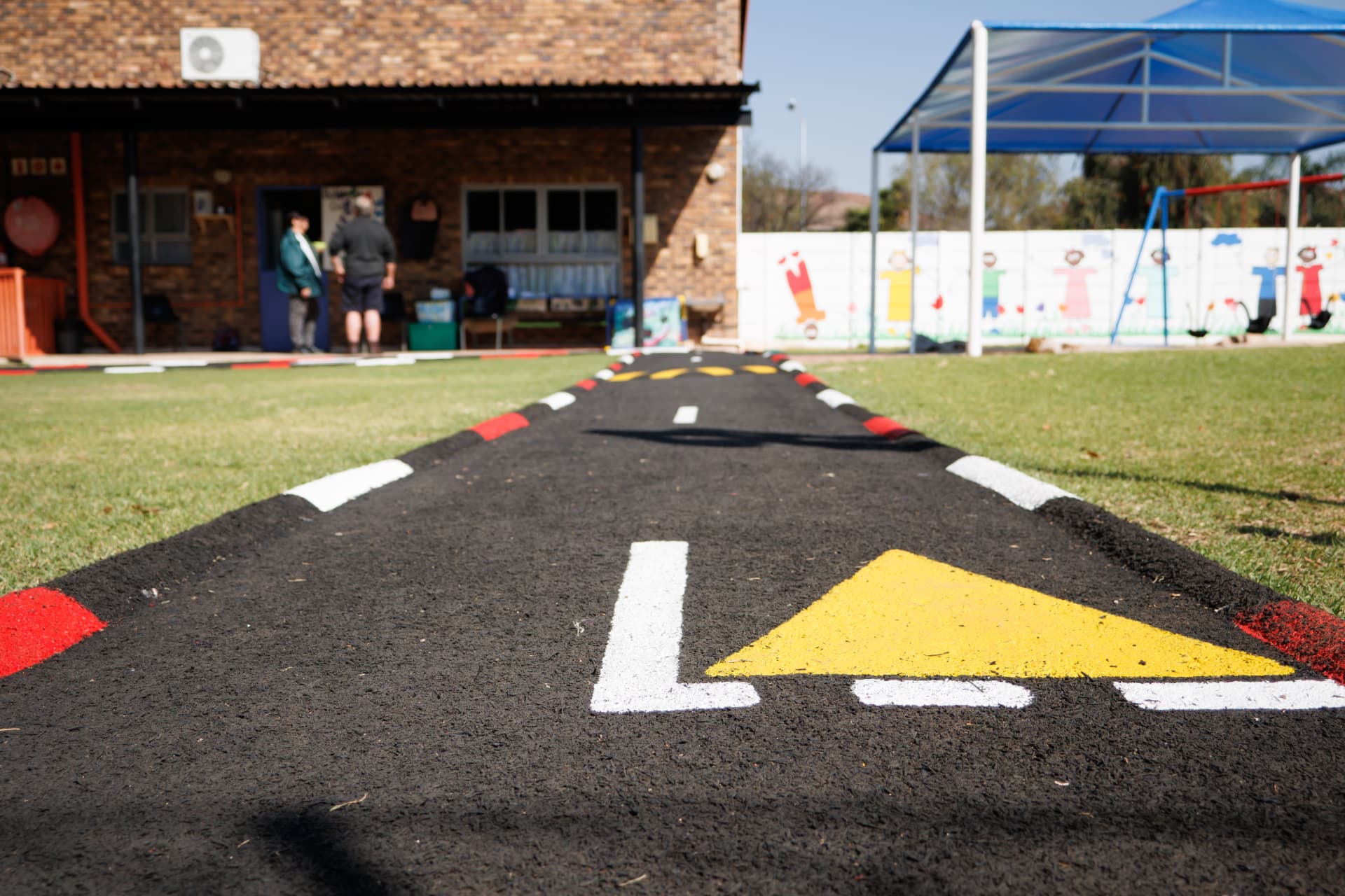 Painted play road track running across the grounds